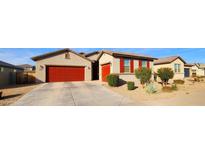Single-story home with red garage door and landscaped front yard at 37444 W Leonessa Ave, Maricopa, AZ 85138