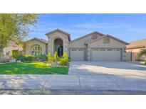 Charming single-story home featuring a spacious three-car garage and landscaped front yard at 957 E Cedar Dr, Chandler, AZ 85249