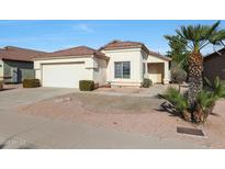 Single-story house with a two-car garage and desert landscaping at 2042 E Aire Libre Ave, Phoenix, AZ 85022