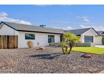Charming single story home featuring low maintenance landscaping and a well-manicured lawn in front at 3807 N 87Th St, Scottsdale, AZ 85251