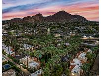 Beautiful aerial view of the community homes with palm trees and mountain views at sunset at 4540 N 44Th St # 41, Phoenix, AZ 85018
