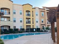 Inviting community pool with apartment building in background at 14575 W Mountain View Blvd # 11317, Surprise, AZ 85374