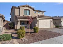 Two-story house with a beige exterior, two-car garage, and landscaping at 480 W Cucumber Tree Ave, Queen Creek, AZ 85140
