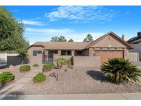 Single story home with landscaped front yard and gated entry at 930 E Kristal Way, Phoenix, AZ 85024