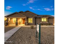 Single-story home with a light brown exterior, a walkway, and desert landscaping at 1 N Brenner Pass Rd, Queen Creek, AZ 85144