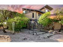 A unique two-story home with stone accents and a desert landscape at 16409 E Kingstree Blvd, Fountain Hills, AZ 85268
