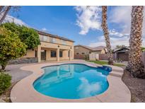 Inviting kidney shaped pool with surrounding patio at 1923 E Zion Way, Chandler, AZ 85249