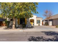 One-story home with yellow door and shutters, landscaped yard at 17388 W Navajo St, Goodyear, AZ 85338