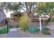 Front view of a two-story home with a landscaped yard and brick pathway at 25150 N Windy Walk Dr # 39, Scottsdale, AZ 85255