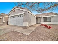 Single story home with attached garage and landscaped front yard at 8275 N 112Th Ave, Peoria, AZ 85345