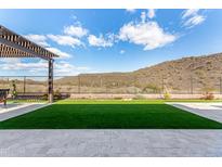 Artificial turf backyard with pergola and mountain views at 11578 W Montansoro Ln, Peoria, AZ 85383