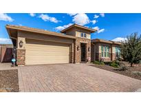 Craftsman style home with stone accents and a 3-car garage at 11578 W Montansoro Ln, Peoria, AZ 85383