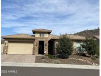 Single-story home with stone accents and a three-car garage at 11578 W Montansoro Ln, Peoria, AZ 85383