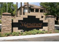 The Signature Condominium Homes entrance sign with stone pillars and landscaping at 15095 N Thompson Peak Pkwy # 1041, Scottsdale, AZ 85260