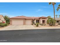 Single-story home with tile roof, two-car garage, and desert landscaping at 19808 N Shadow Mountain Dr, Surprise, AZ 85374