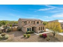 Two-story house with solar panels, pool, and landscaped yard at 31271 N 133Rd Dr, Peoria, AZ 85383