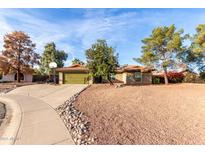 Single-story home with green garage door and landscaped yard at 944 W Diamond Dr, Tempe, AZ 85283
