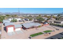 Aerial view of single story home, detached garage, and landscaped yard at 11120 E Grove St, Mesa, AZ 85208