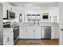 Modern kitchen with stainless steel appliances and white cabinetry at 19777 N 76Th St # 3266, Scottsdale, AZ 85255