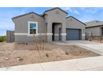 Charming single-story home boasts a well-maintained xeriscaped front yard and neutral colored stucco at 25425 W Graham Trl, Buckeye, AZ 85326