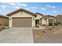 One-story house with two-car garage, desert landscaping, and neutral color scheme at 26180 W Firehawk Dr, Buckeye, AZ 85396