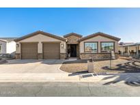 Two-car garage, stone accents, and a paved driveway characterize this home's exterior at 2645 N Lema Dr, Mesa, AZ 85215