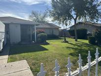 Ranch style home with a well-manicured lawn and decorative fountain at 4625 W Sheridan St, Phoenix, AZ 85035