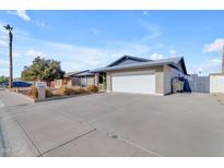 Single-story home with a two-car garage and well-maintained landscaping at 4738 W Vogel Ave, Glendale, AZ 85302