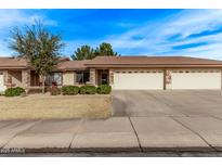 Tan two-story home with three-car garage and landscaped front yard at 11360 E Keats Ave # 83, Mesa, AZ 85209