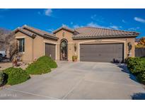 Single-story home with a two-car garage and landscaped front yard at 16140 W Almeria Rd, Goodyear, AZ 85395