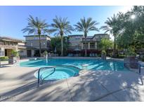 Refreshing community pool and spa with lounge chairs and palm trees at 17850 N 68Th St # 2072, Phoenix, AZ 85054