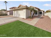 House exterior with artificial turf and desert landscaping at 4338 E Desert Trumpet Rd, Phoenix, AZ 85044