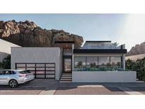Contemporary home exterior boasts clean lines, modern design, glass garage door, and mountain views at 5761 N Echo Canyon Cir, Phoenix, AZ 85018