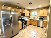 Bright kitchen features stainless steel appliances and granite countertops at 14820 N 35Th St, Phoenix, AZ 85032