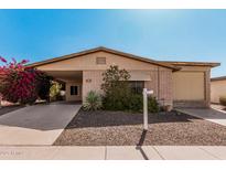Charming single story home with a brick facade, covered carport, and desert landscaping at 2233 N Middlecoff Dr, Mesa, AZ 85215