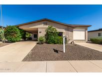 Charming single-story home features desert landscaping, neutral paint, and a covered carport at 2233 N Middlecoff Dr, Mesa, AZ 85215