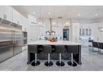 Gourmet kitchen boasts expansive island, stainless steel appliances, and ample cabinetry at 23807 N 64Th Ave, Glendale, AZ 85310