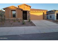 One-story home with a two-car garage and desert landscaping at 31363 N 130Th Ave, Peoria, AZ 85383