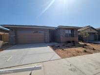 Charming single-story home featuring stone accents, a two-car garage, and desert landscaping at 31363 N 130Th Ave, Peoria, AZ 85383