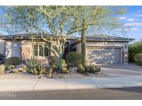 Single-story home with desert landscaping and a two-car garage at 3525 E Robin Ln, Phoenix, AZ 85050