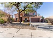 Two-story house with brown garage door and desert landscaping at 4293 S Columbine Way, Gold Canyon, AZ 85118