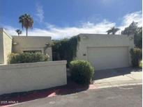 Tan stucco house with a two-car garage and mature landscaping at 4727 E Euclid Ave, Phoenix, AZ 85044