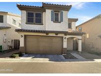 Two-story stucco home with a brown garage door and landscaped yard at 4738 E Tierra Buena Ln, Phoenix, AZ 85032