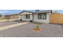 Newly renovated home with a modern exterior and well-manicured front yard at 5823 S 34Th Pl, Phoenix, AZ 85040