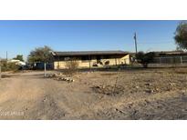 Ranch style home with covered porch and chain link fence at 12629 S Tuthill Rd, Buckeye, AZ 85326