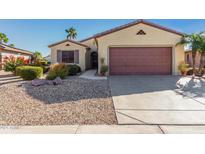 Single-story home with desert landscaping and a two-car garage at 15041 W Wrigley Way, Surprise, AZ 85374