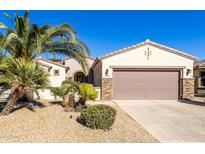Single-story home with desert landscaping and a two-car garage at 16336 W Salado Creek Dr, Surprise, AZ 85387