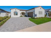 Beautiful single Gathering home with a paver driveway and desert landscaping at 17206 W Middlebury St, Surprise, AZ 85388