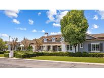 Gray farmhouse exterior with large windows and manicured landscaping at 4802 N 46Th St, Phoenix, AZ 85018