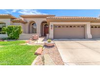 Beautiful home exterior with a two-car garage and manicured lawn at 5535 E Sheena Dr, Scottsdale, AZ 85254